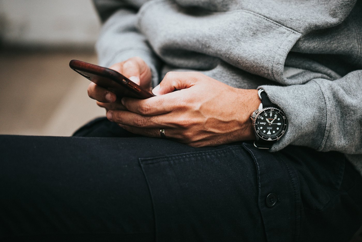Hands holding a phone and reading a message