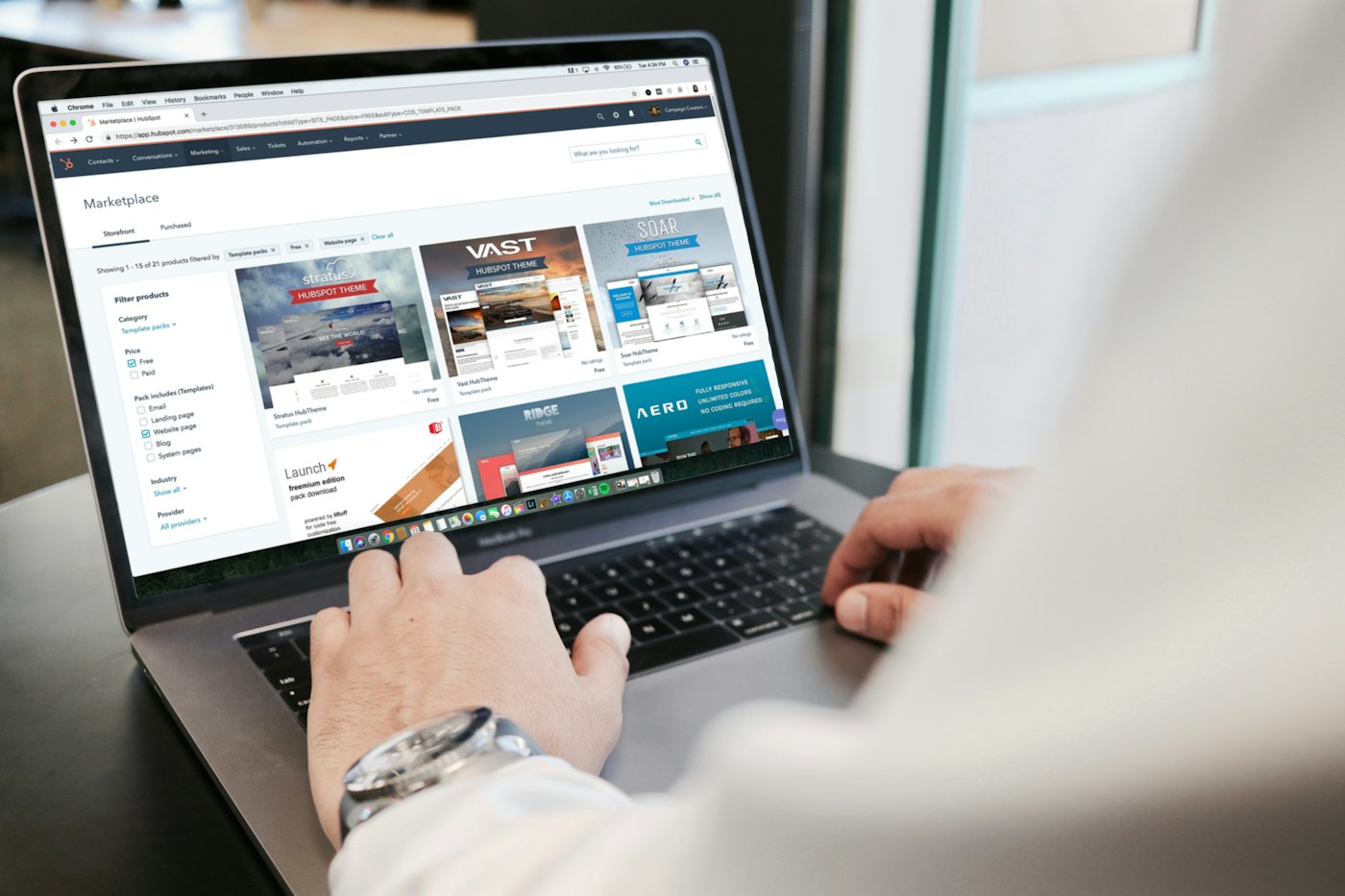 A laptop open on a web page on a white desk